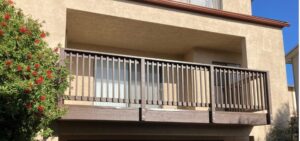 Front view of a house with a balcony above a garage